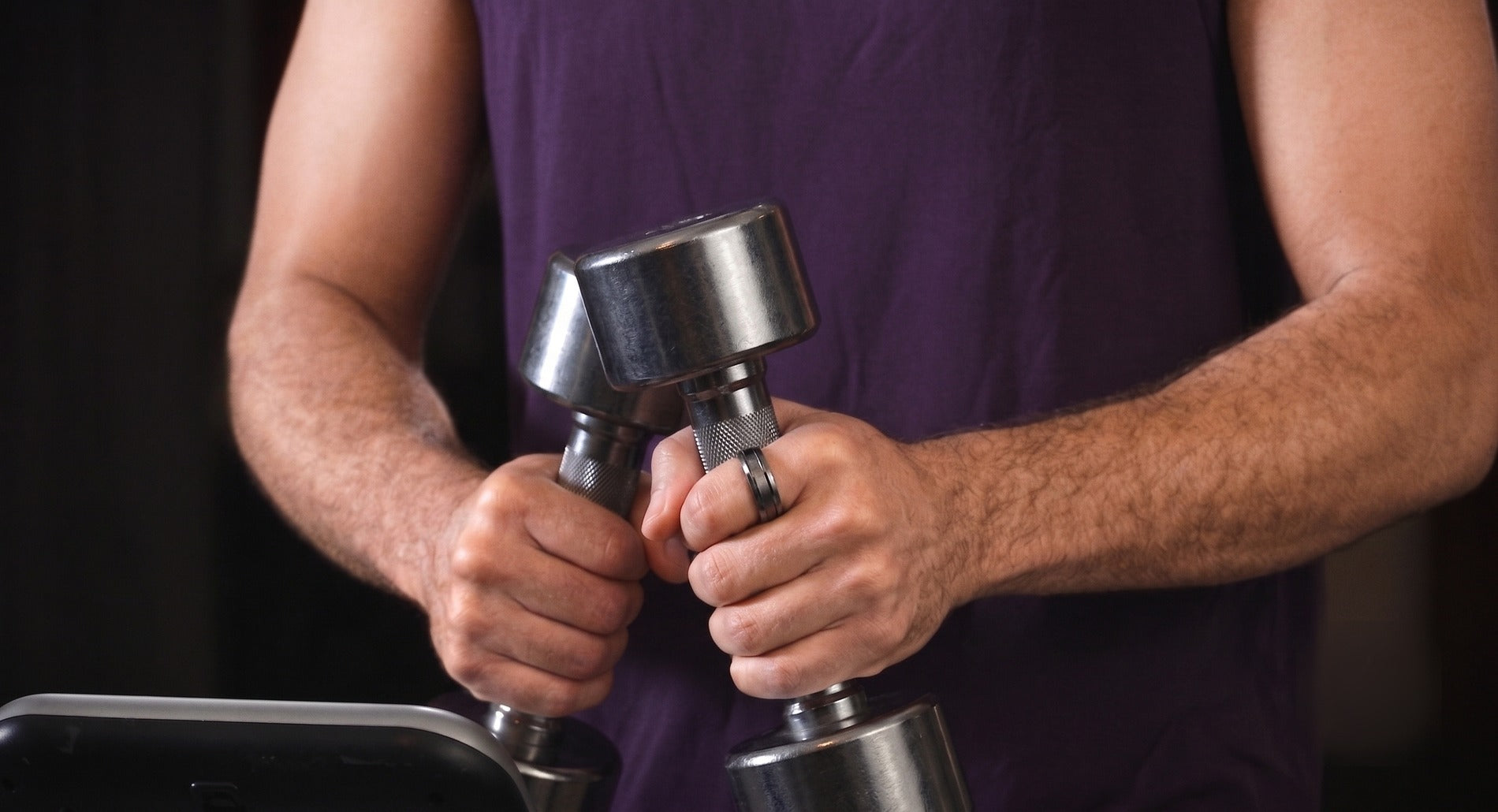 Ring One Gen-2 worn during a dumbbell workout, showing the coating holding up under metal-to-metal contact